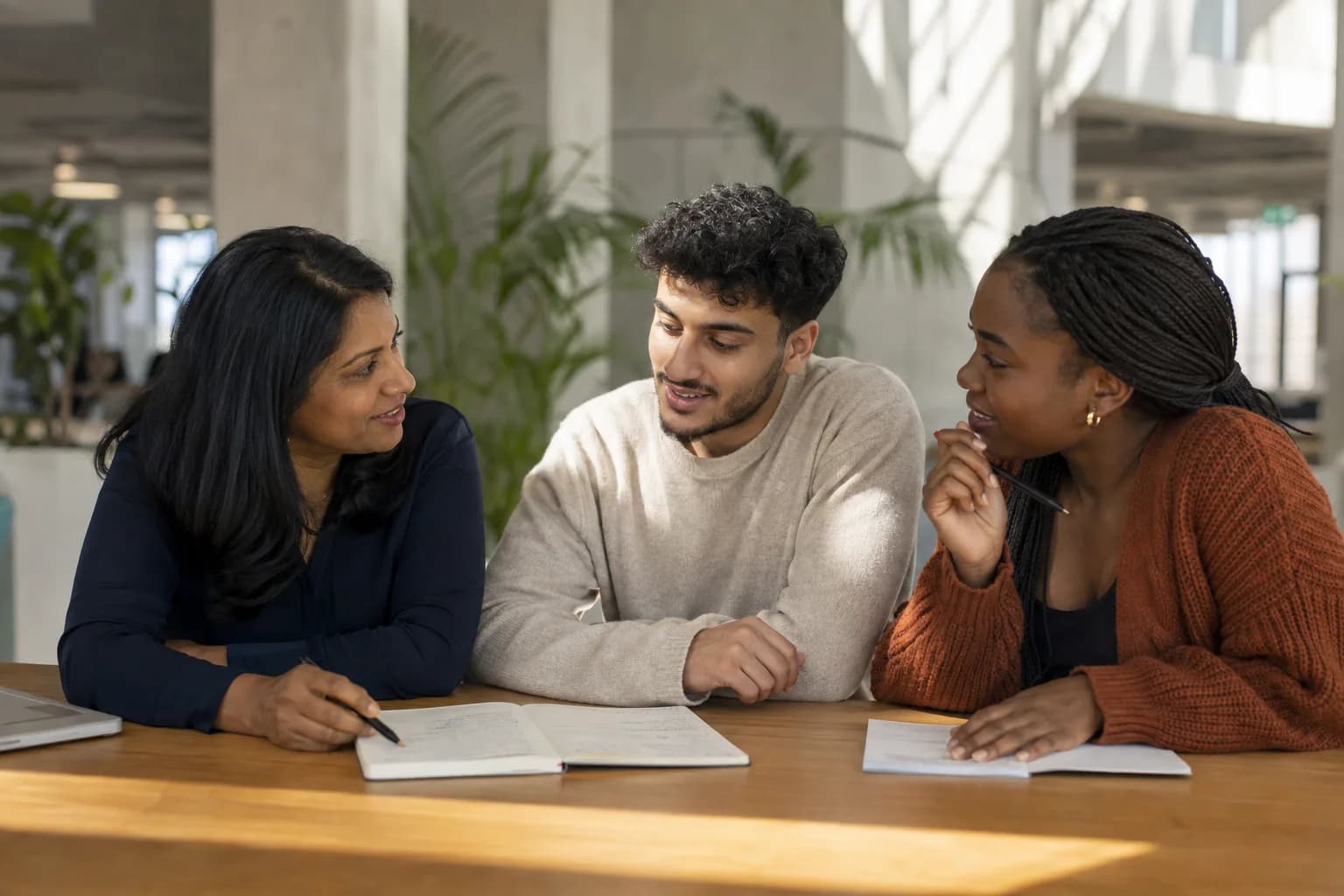 An educator and learners sharing an encouraging conversation